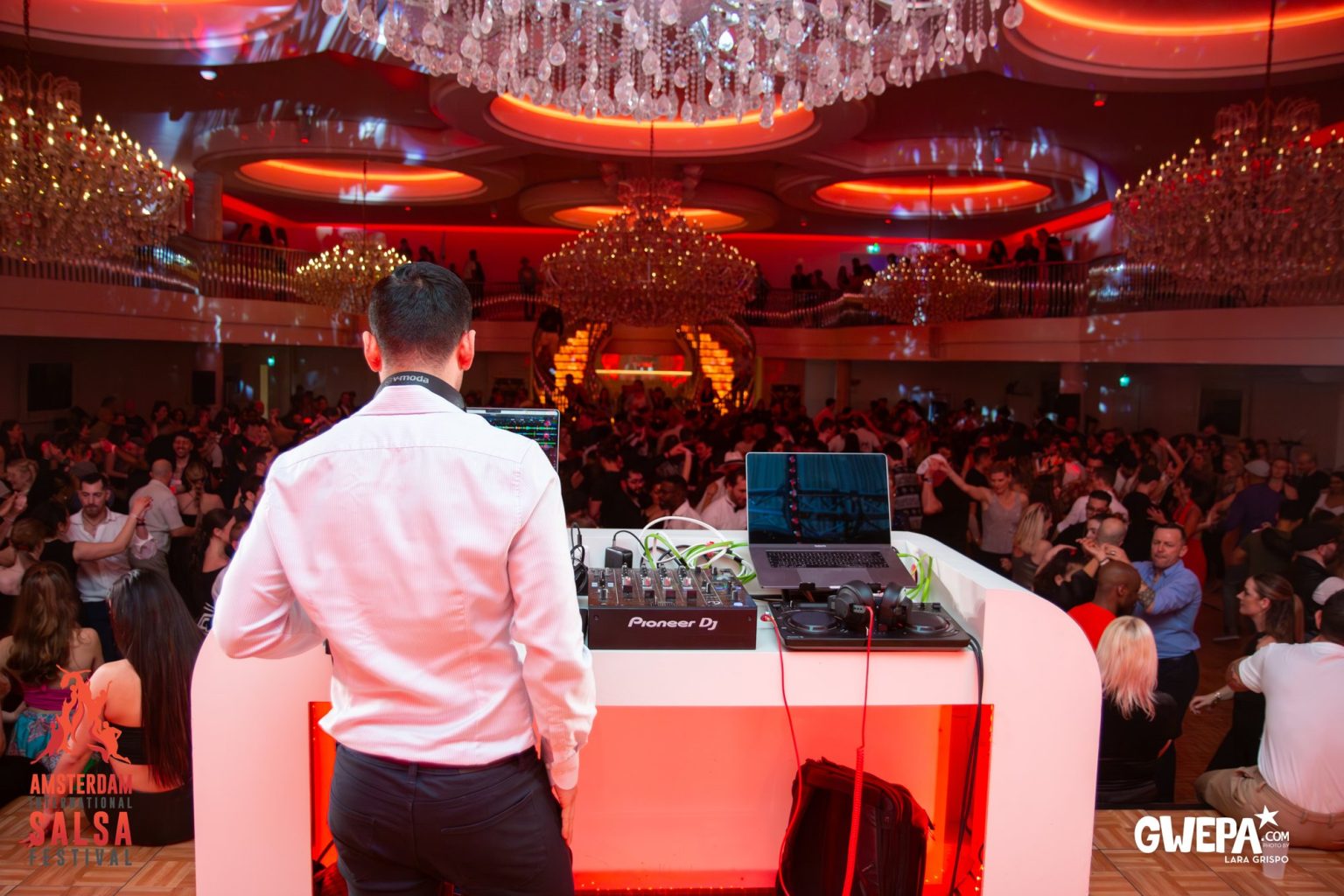 A DJ looking out over a full room at the festival
